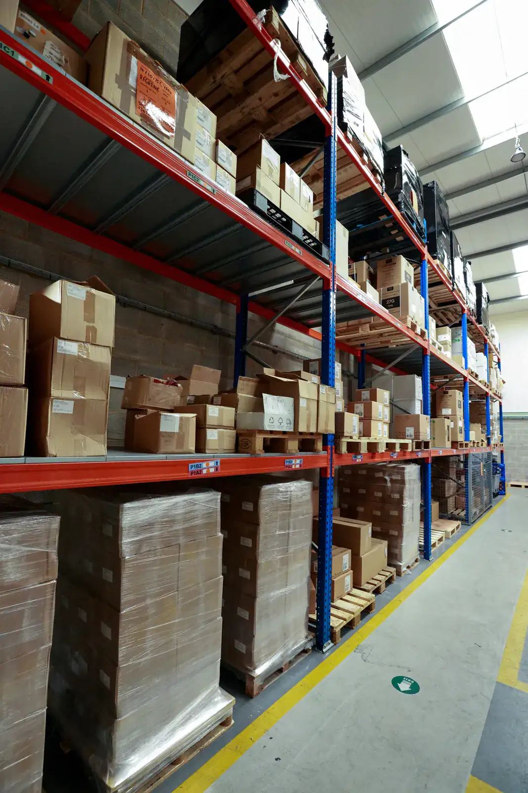 Pallet racking aisle with boxed stock on timber decking