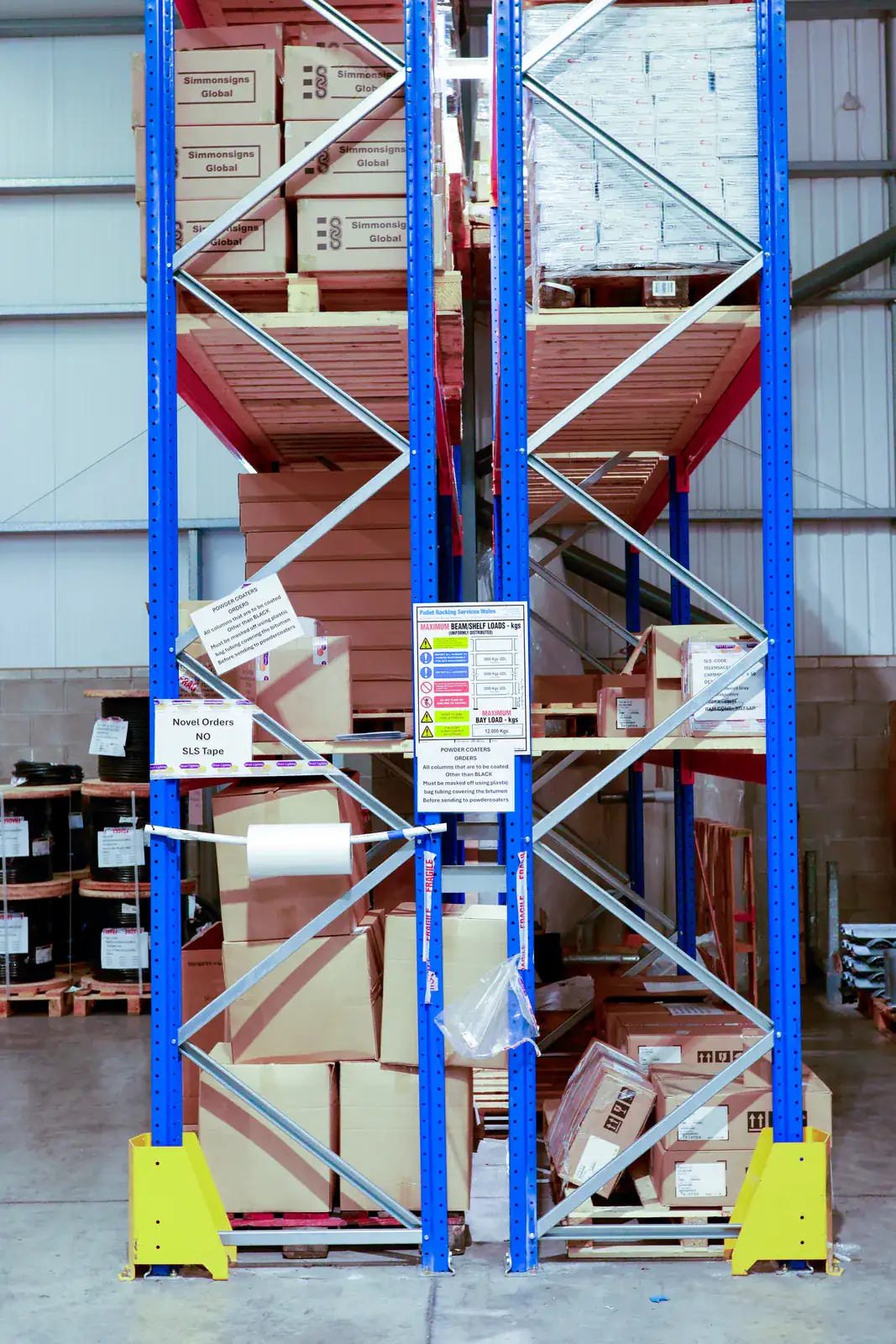 Pallet racking end frames with a load notice and footplate protectors