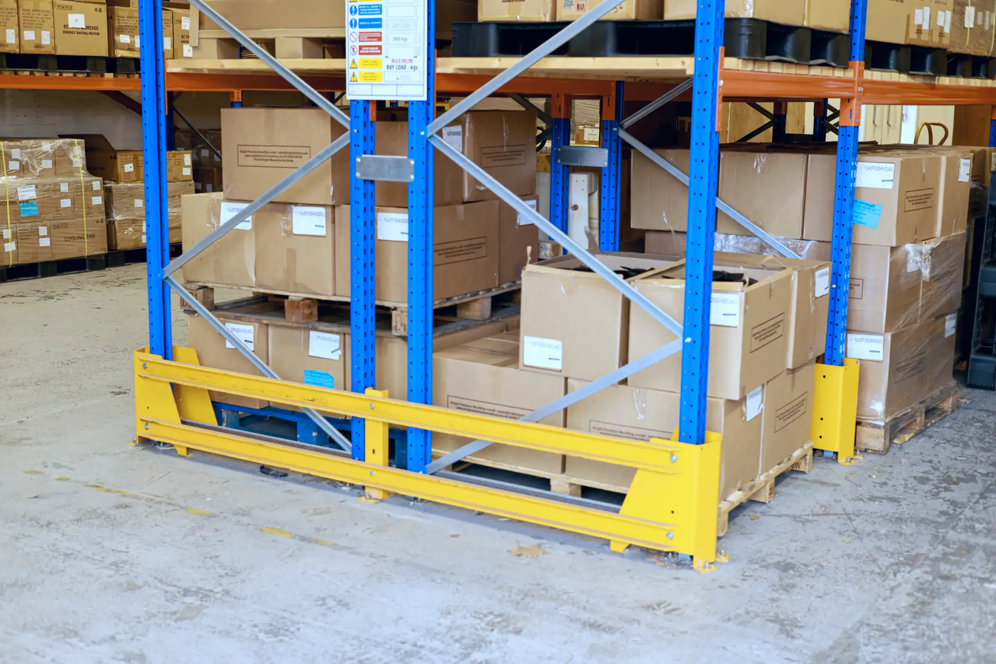 Wide aisle pallet racking with yellow end of aisle barrier protection